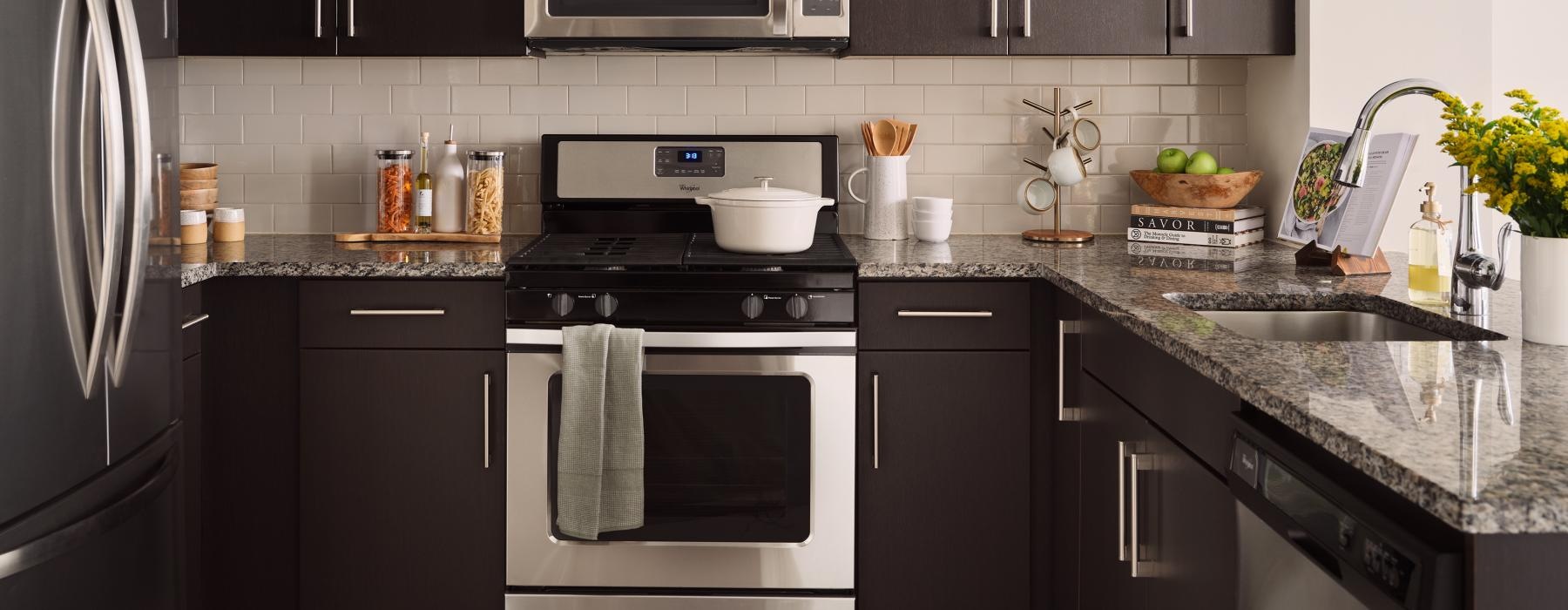 a kitchen with black cabinets